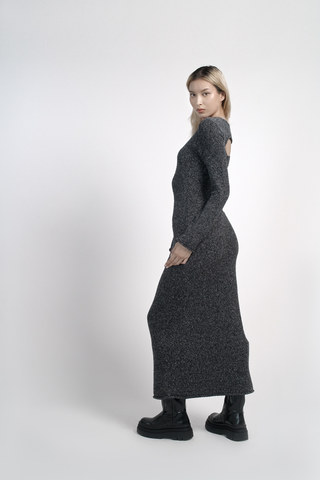 Girl in a black  maxi dress. Made of headstock. 